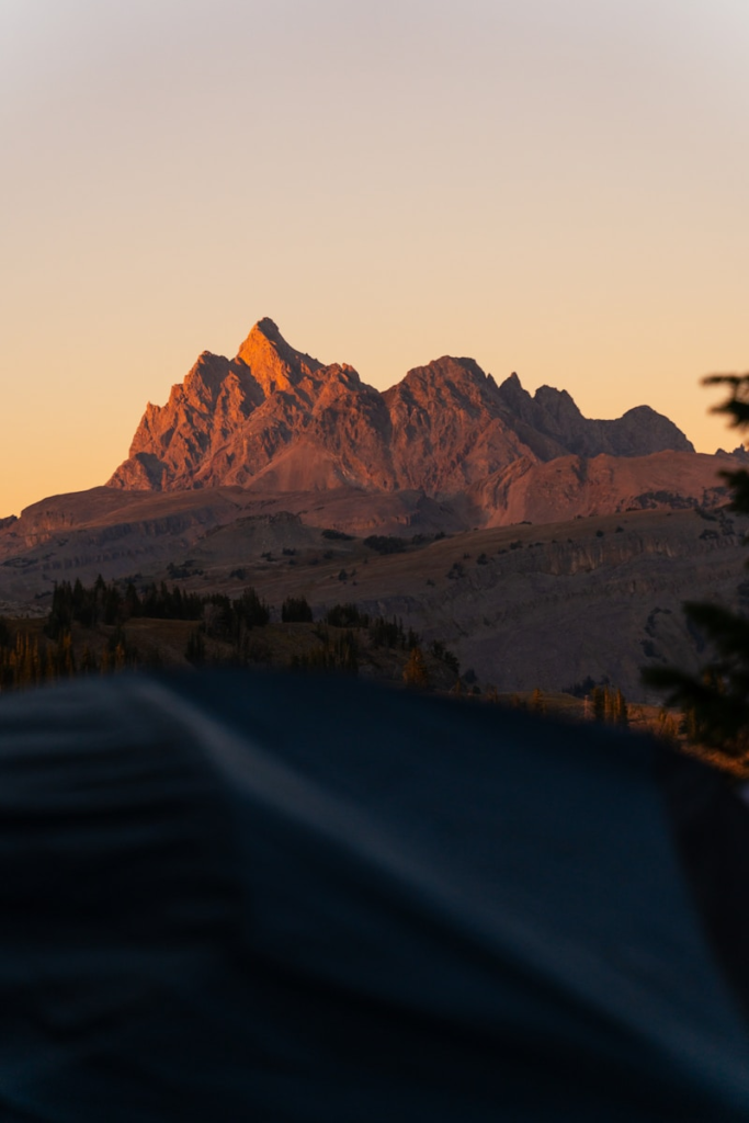 Jagged mountain peaks illuminated by golden hour sunlight